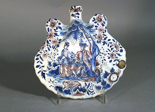 French Faience French Faience Flask In The Form of A Scallop Shell Decorated In Blue And Manganese With Courting And Hunting Scenes,, Circa 1720. SOLD •