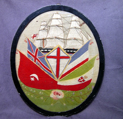 Inventory: An Unusual Oval  English Sailor's Woolwork Picture of Ship and Flags, Circa 1880 SOLD &bull;