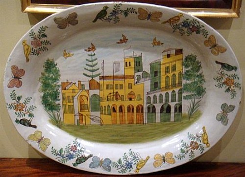A Large Italian Tin-glazed Earthenware Dish decorated with Buildings,  20th century SOLD •