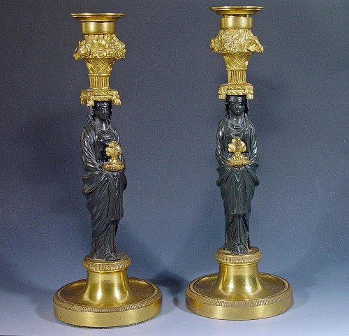 A Pair of French Bronze and Ormolu Candleholders with Vestal Figural Stems, Circa 1815-30. SOLD •