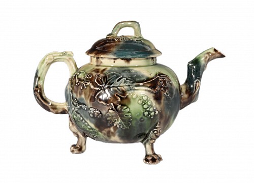 Inventory:  Creamware Pottery, Whieldon-Type Creamware Tortoiseshell-Glazed Teapot and Cover with Grape Vine Relief, Staffordshire, 1765-75, $3,750